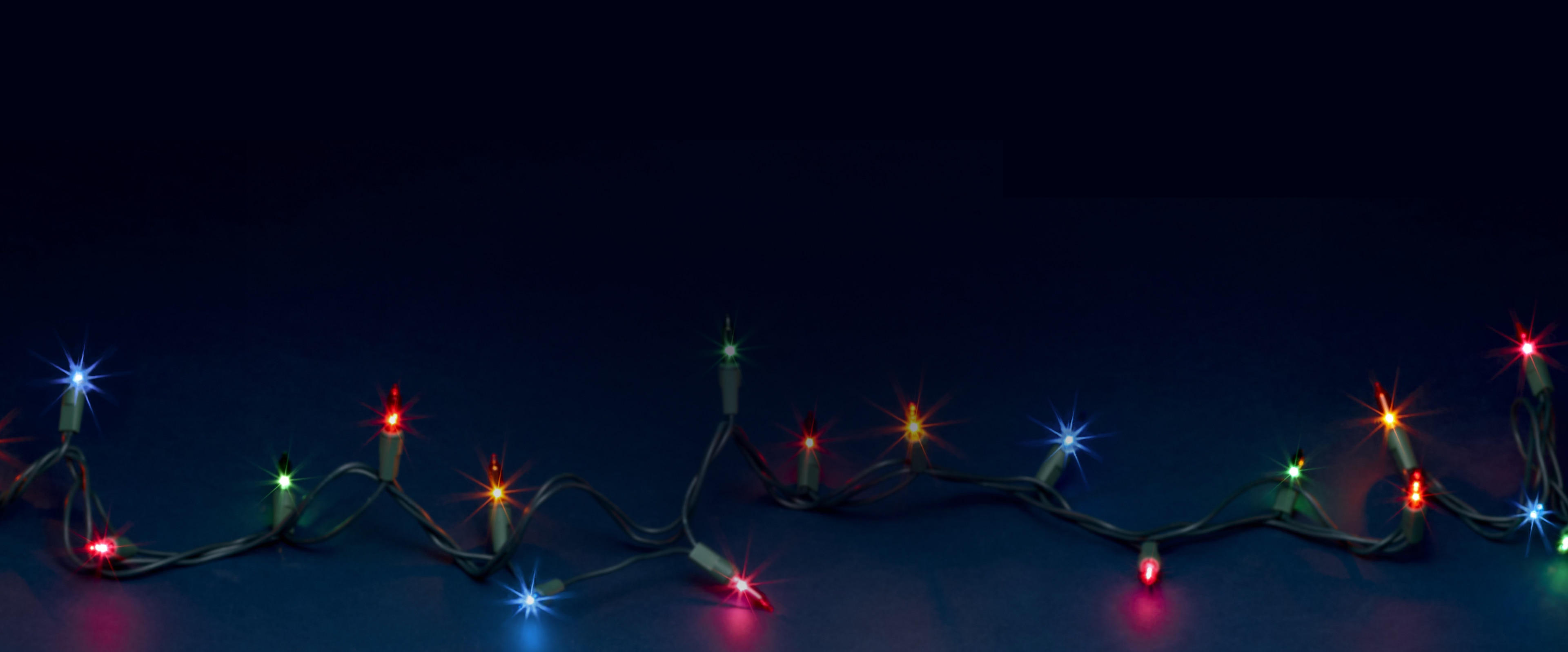 Shop Nunn Bush black Friday featuring a navy background with colored Christmas lights.