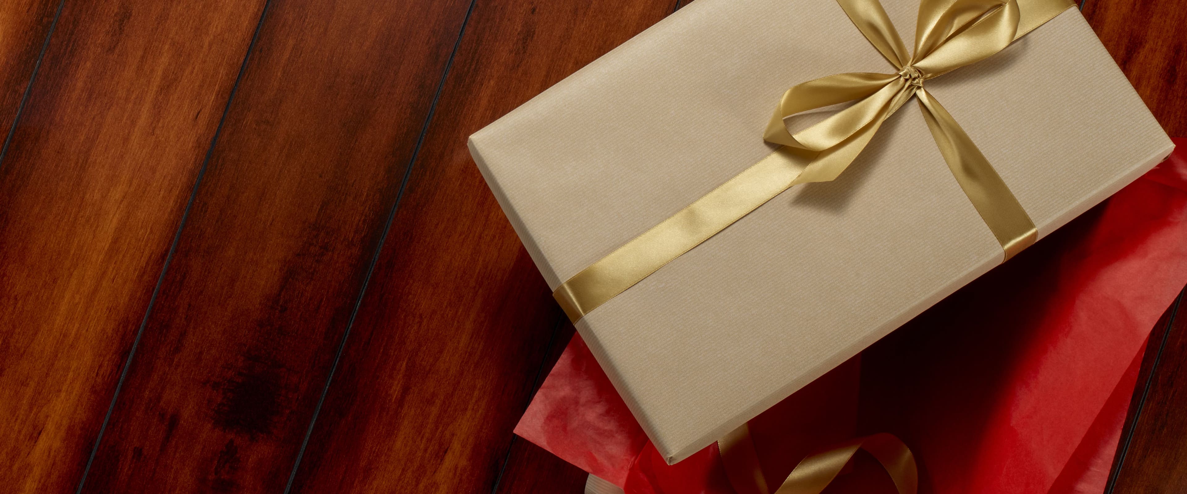 Extended 24 hours! Shop our Cyber Monday sale featuring a stack of gifts on a wood background.