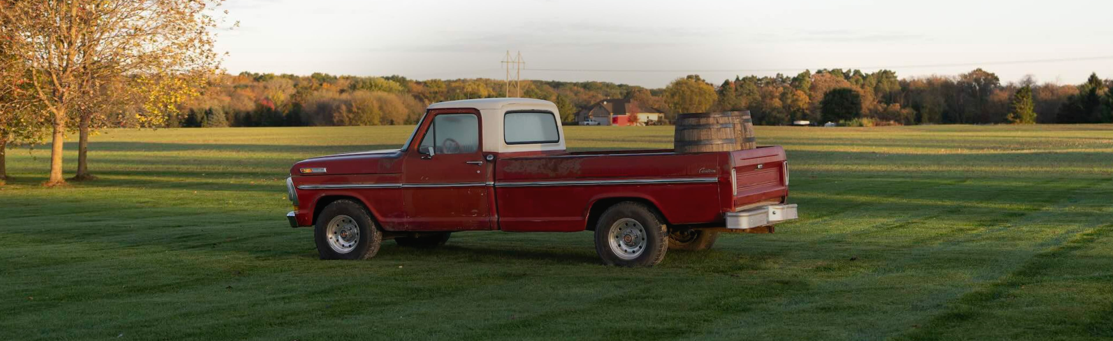 Shop our October Super Deal for up to 60% off select styles with no promo code needed, while supplies last. Image features a red pick-up truck parked in the middle of a grassy field.