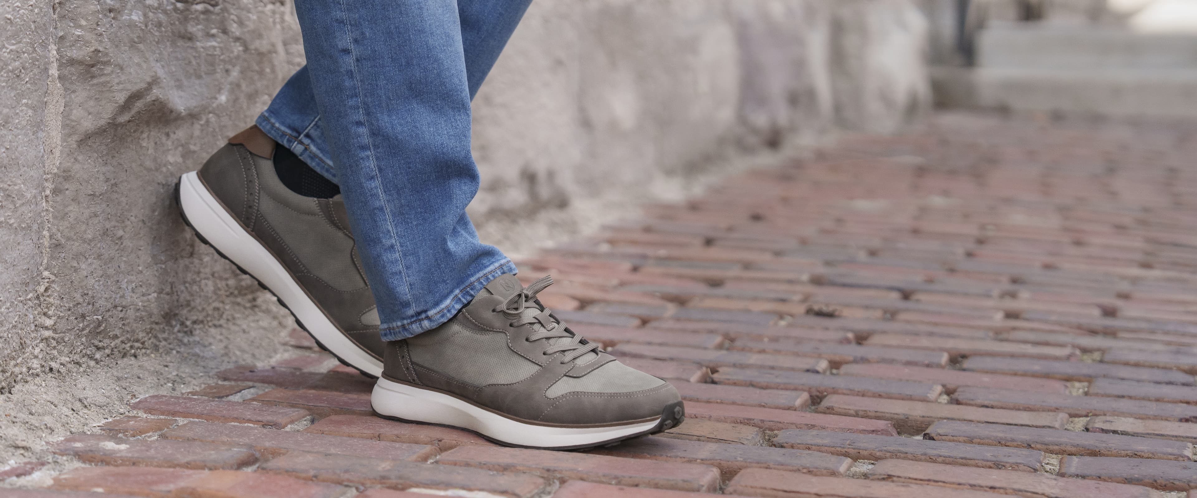 Image features the KORE Swift sneaker on a brick walkway.
