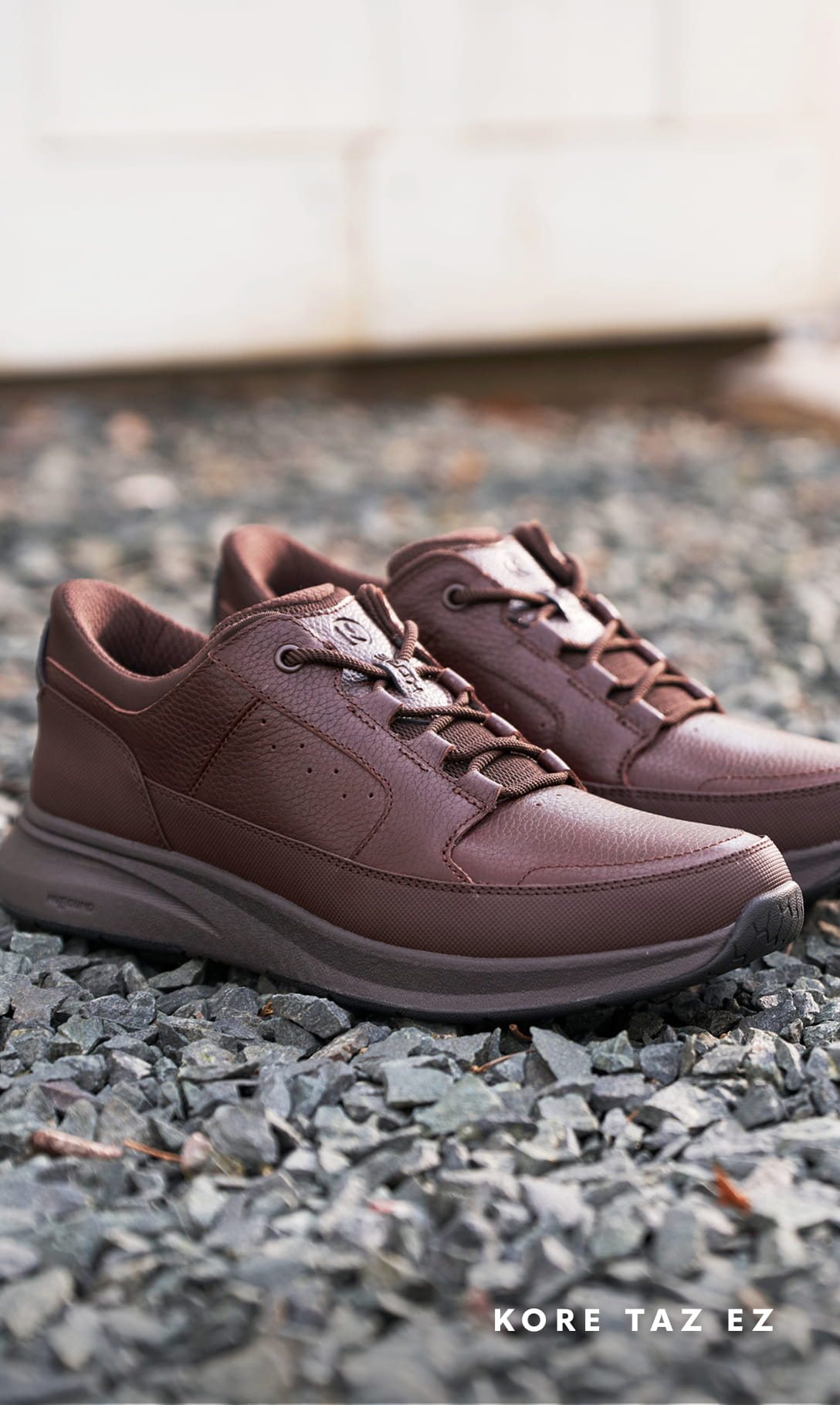Men's Casual Shoes category. Image features the Taz EZ Oxford in brown on gravel.