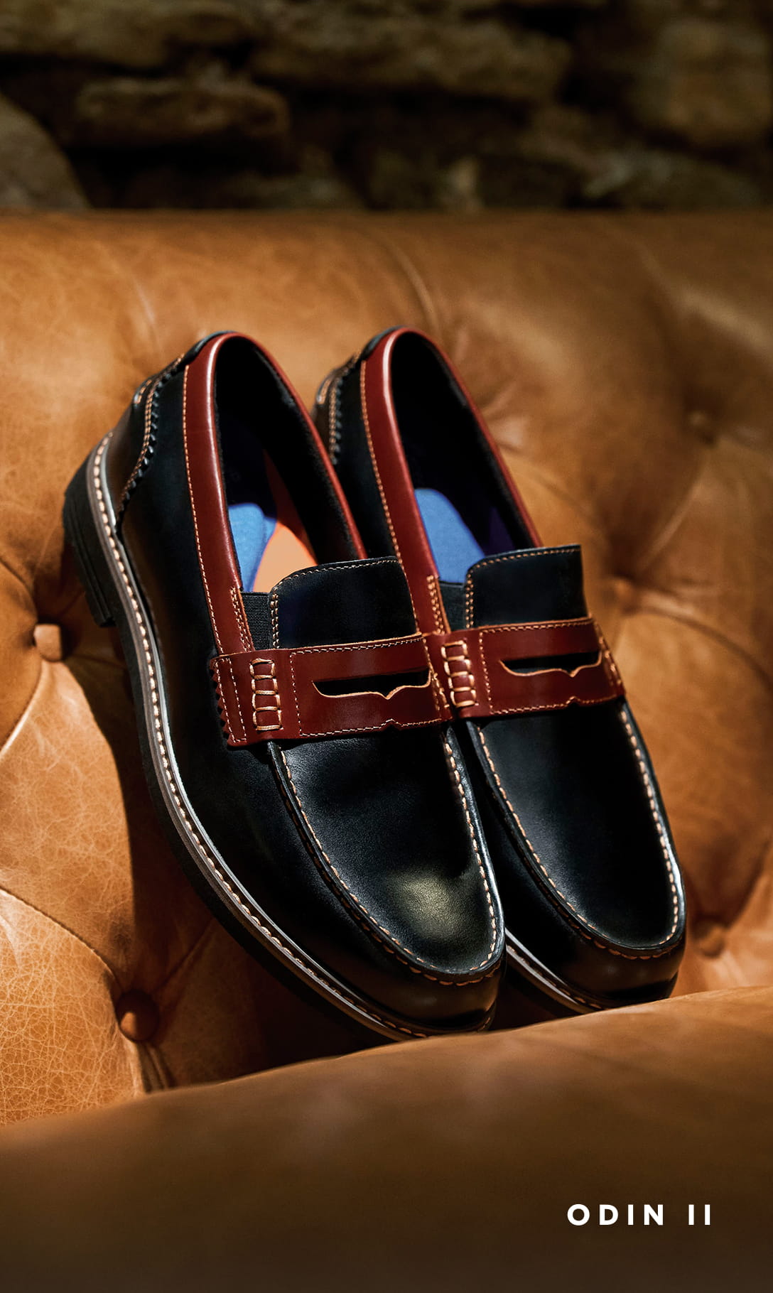 Men's Dress Shoes category. Image features the Odin II in black on a cognac leather sofa.